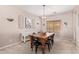 Warm and inviting dining room with a rustic wooden table and a large, bright window at 10684 N 161St Ave, Surprise, AZ 85379