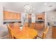 Cozy eat-in kitchen area with a wooden dining table and an island view at 10684 N 161St Ave, Surprise, AZ 85379