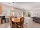 Charming dining area with a wooden table, seating for six, and adjacent living space at 10684 N 161St Ave, Surprise, AZ 85379