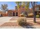 Charming two-story home with a tile roof, arched windows, and desert landscaping at 10684 N 161St Ave, Surprise, AZ 85379