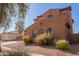 Two-story home with a tile roof, desert landscaping, and a detached garage at 10684 N 161St Ave, Surprise, AZ 85379