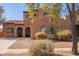 Charming two-story home with a tile roof, arched windows, and desert landscaping at 10684 N 161St Ave, Surprise, AZ 85379