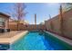 Sparkling in-ground pool surrounded by a concrete deck and desert landscaping at 10684 N 161St Ave, Surprise, AZ 85379