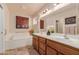 Bathroom featuring a bathtub and dual sinks at 11530 E Monterey Ave, Mesa, AZ 85209