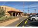 Community clubhouse featuring stucco exterior, arches, and desert landscaping at 11530 E Monterey Ave, Mesa, AZ 85209