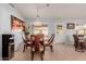 Bright dining area with a round table, four chairs, and unique lighting at 11530 E Monterey Ave, Mesa, AZ 85209