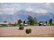 Golf carts parked on the course with scenic mountain views in the background at 11530 E Monterey Ave, Mesa, AZ 85209