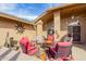 Inviting patio with comfortable seating, string lights, and decorative sun art, perfect for outdoor gatherings at 11530 E Monterey Ave, Mesa, AZ 85209