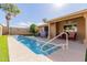 A view of the backyard and pool area with a covered patio and outdoor seating for relaxing or entertaining at 11530 E Monterey Ave, Mesa, AZ 85209