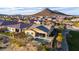 Aerial perspective of a fenced backyard with a sparkling pool, complemented by desert landscaping and mountain views at 12413 W Calle De Baca --, Peoria, AZ 85383