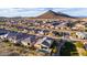 Desert community aerial showcasing backyard with pool and mountain views in the background at 12413 W Calle De Baca --, Peoria, AZ 85383