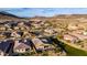 Aerial view of homes in a desert community; a backyard oasis features a pool and green space at 12413 W Calle De Baca --, Peoria, AZ 85383