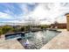 Backyard featuring a pool with a fountain, poolside landscaping, and lounge chairs for relaxation at 12413 W Calle De Baca --, Peoria, AZ 85383