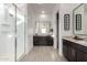 Bright bathroom featuring double vanity with granite countertops and a glass-enclosed shower at 12413 W Calle De Baca --, Peoria, AZ 85383