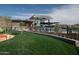 Exterior shot of the community clubhouse with well-maintained landscaping, and a play area for residents to enjoy at 12413 W Calle De Baca --, Peoria, AZ 85383