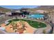 Aerial view of the community pool and playground area surrounded by the desert landscape at 12413 W Calle De Baca --, Peoria, AZ 85383