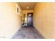 Inviting entryway with a dark wood door, neutral stucco walls, and decorative potted plants at 12413 W Calle De Baca --, Peoria, AZ 85383