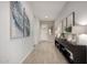 Bright entryway featuring wood-look tile flooring, a console table, and modern wall art at 12413 W Calle De Baca --, Peoria, AZ 85383