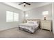 Bright primary bedroom with neutral colors, a ceiling fan, and carpeted floors at 12413 W Calle De Baca --, Peoria, AZ 85383