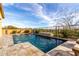 Relaxing pool area featuring cool blue water, a tranquil fountain, and a meticulously landscaped yard at 12413 W Calle De Baca --, Peoria, AZ 85383