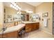 Bathroom featuring dual sinks, granite countertops, and custom tiled backsplash at 12835 W Black Hill Rd, Peoria, AZ 85383