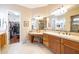 Bathroom featuring a vanity area, dual sinks, and a large walk-in closet at 12835 W Black Hill Rd, Peoria, AZ 85383