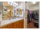 Bathroom featuring a sink with wooden cabinets and large walk-in closet at 12835 W Black Hill Rd, Peoria, AZ 85383