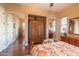 Bedroom with hardwood floors, mirrored closet doors and natural light at 12835 W Black Hill Rd, Peoria, AZ 85383