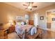 Bedroom with hardwood floors, a ceiling fan, and lots of natural light at 12835 W Black Hill Rd, Peoria, AZ 85383