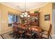 Elegant dining room with a large table, chandelier, and stylish furnishings at 12835 W Black Hill Rd, Peoria, AZ 85383