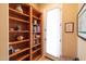 Hallway with a bookshelf, doorway to exterior, and picture frame decor at 12835 W Black Hill Rd, Peoria, AZ 85383