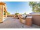 Outdoor kitchen on a brick patio with a grill, sink, and counter space at 12835 W Black Hill Rd, Peoria, AZ 85383