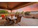 Covered patio with dining table, seating area, and a scenic backyard view at 12835 W Black Hill Rd, Peoria, AZ 85383