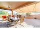 Covered patio with brick flooring, an outdoor table, seating, and a ceiling fan at 12835 W Black Hill Rd, Peoria, AZ 85383