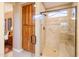 Bathroom featuring tiled walk-in shower with glass door and built-in seat at 12835 W Black Hill Rd, Peoria, AZ 85383