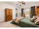 Well-lit bedroom with a quaint chair next to the bright window at 12936 W Sola Dr, Sun City West, AZ 85375