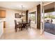 Charming dining area with french doors to the patio, elegant chandelier, and four-seat wooden table at 12936 W Sola Dr, Sun City West, AZ 85375