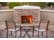 Outdoor stone fireplace with a cozy seating area, perfect for entertaining or relaxing at 12936 W Sola Dr, Sun City West, AZ 85375