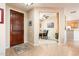 Grand foyer with a wooden door leading into an elegant dining area at 12936 W Sola Dr, Sun City West, AZ 85375