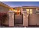 Beautiful front entrance featuring a gated courtyard with a red door at 12936 W Sola Dr, Sun City West, AZ 85375