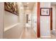 Neutral hallway featuring tile flooring with access to many rooms at 12936 W Sola Dr, Sun City West, AZ 85375