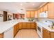 Bright kitchen featuring a breakfast bar, white appliances, and plenty of counter space open to the living room at 12936 W Sola Dr, Sun City West, AZ 85375