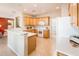 Bright kitchen featuring a breakfast bar, white appliances, and plenty of counter space at 12936 W Sola Dr, Sun City West, AZ 85375