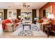 Inviting living room featuring neutral sofas, ceiling fan, stylish rug, and a view to the outdoor patio at 12936 W Sola Dr, Sun City West, AZ 85375