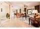 Open living room with tile floors, a ceiling fan, and large windows overlooking the backyard at 12936 W Sola Dr, Sun City West, AZ 85375