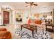 Inviting living room featuring neutral sofas, ceiling fan, stylish rug, and a view to the dining area at 12936 W Sola Dr, Sun City West, AZ 85375