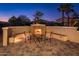 Backyard outdoor fireplace with seating on a brick patio at 12936 W Sola Dr, Sun City West, AZ 85375