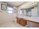 Cozy bathroom featuring a vanity with ample countertop space and a large mirror, creating a functional area at 13232 W Ballad Dr, Sun City West, AZ 85375