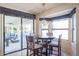 Cozy breakfast nook with a round table and natural light from bay windows at 13232 W Ballad Dr, Sun City West, AZ 85375