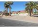 Charming home featuring desert landscaping, mature palm trees, and a two-car garage at 13232 W Ballad Dr, Sun City West, AZ 85375